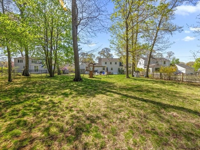 view of yard featuring fence and a residential view