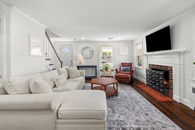 living area with ornamental molding, stairs, wood finished floors, a fireplace, and recessed lighting