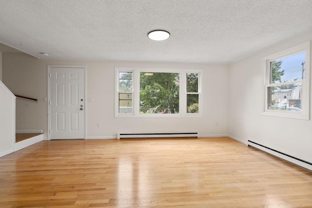 212 Fountain St Unit A, Framingham, MA 01702 - entryway featuring baseboard heating, light wood-type flooring, plenty of natural light, a textured ceiling, and stairway