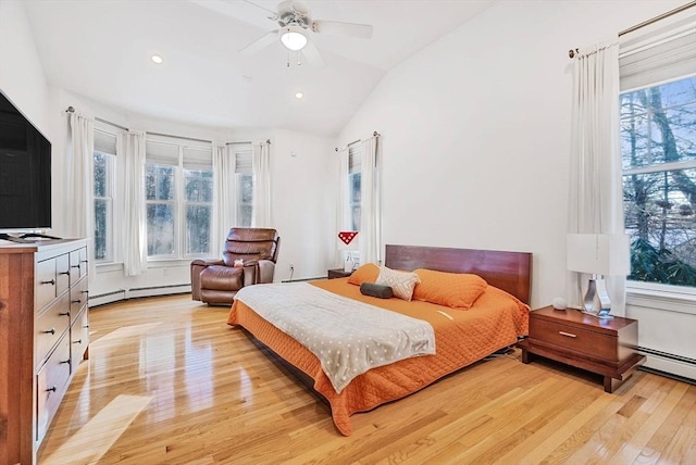 bedroom featuring ceiling fan, a baseboard radiator, lofted ceiling, and light hardwood / wood-style floors