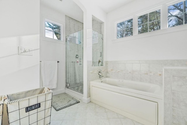 bathroom featuring independent shower and bath