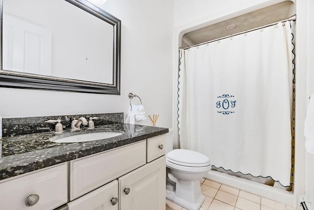 bathroom with tile patterned flooring, a baseboard heating unit, vanity, and toilet