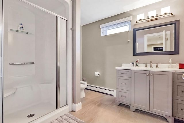 bathroom with baseboard heating, tile patterned flooring, vanity, a shower with shower door, and toilet