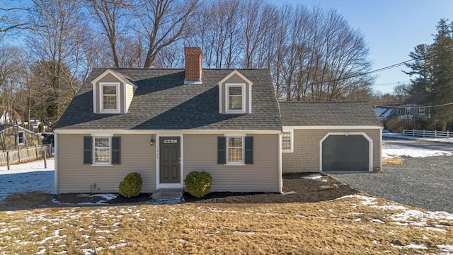 cape cod-style house featuring a garage