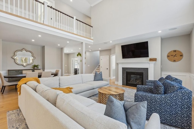 living room with a high ceiling and light wood-type flooring