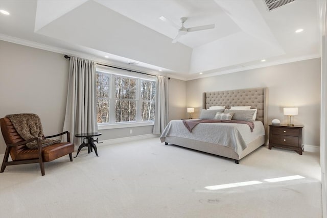 bedroom with a raised ceiling, light carpet, and ceiling fan