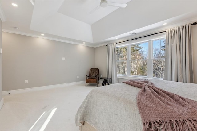 carpeted bedroom with a raised ceiling, crown molding, and ceiling fan