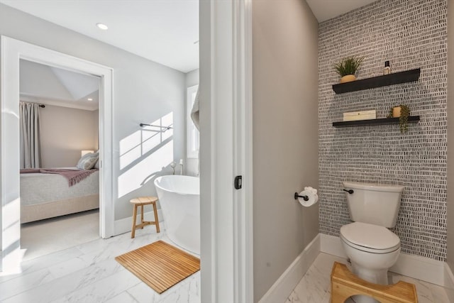 bathroom featuring a bathing tub and toilet