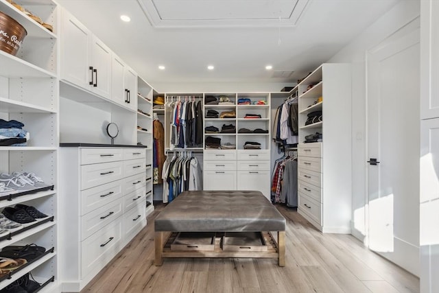 walk in closet with light hardwood / wood-style flooring