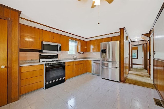 209 Sharp St, Dartmouth, MA 02747 - kitchen with stainless steel appliances, light countertops, tasteful backsplash, brown cabinetry, and ornamental molding