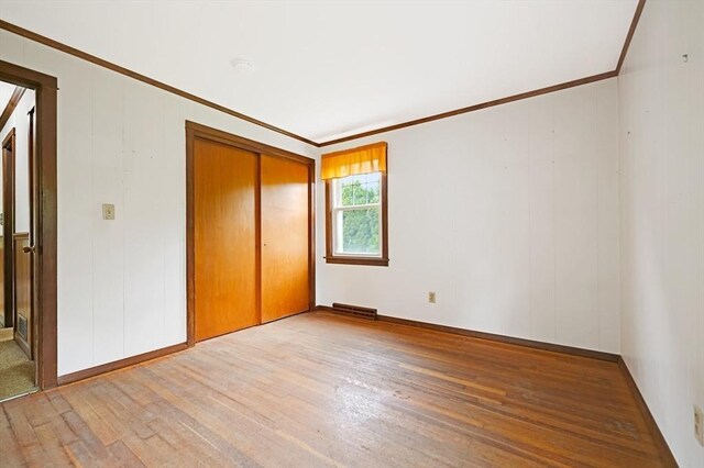 209 Sharp St, Dartmouth, MA 02747 - unfurnished bedroom featuring crown molding, wood finished floors, a closet, and baseboards