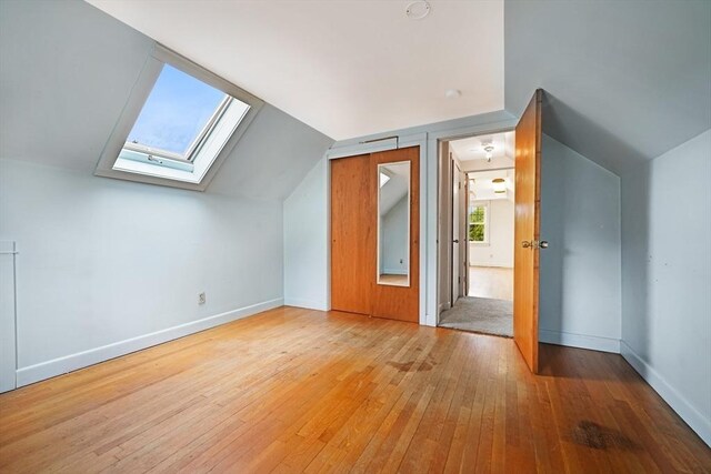 209 Sharp St, Dartmouth, MA 02747 - additional living space featuring hardwood / wood-style flooring, a skylight, lofted ceiling, and baseboards