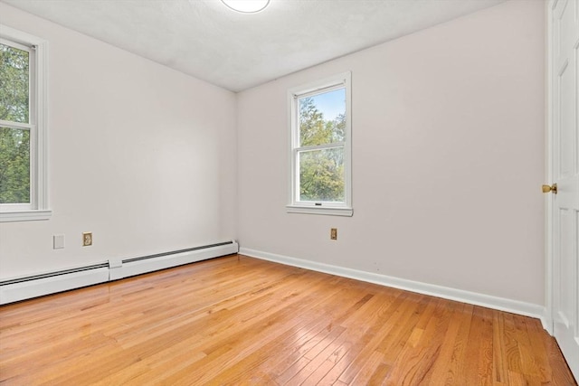 11 Douglas Ave, Burlington, MA 01803 - spare room featuring light wood-style floors, baseboards, and a baseboard heating unit
