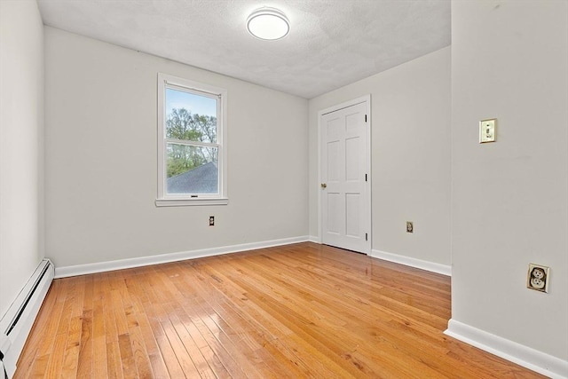 11 Douglas Ave, Burlington, MA 01803 - spare room featuring a baseboard heating unit, light wood finished floors, and baseboards