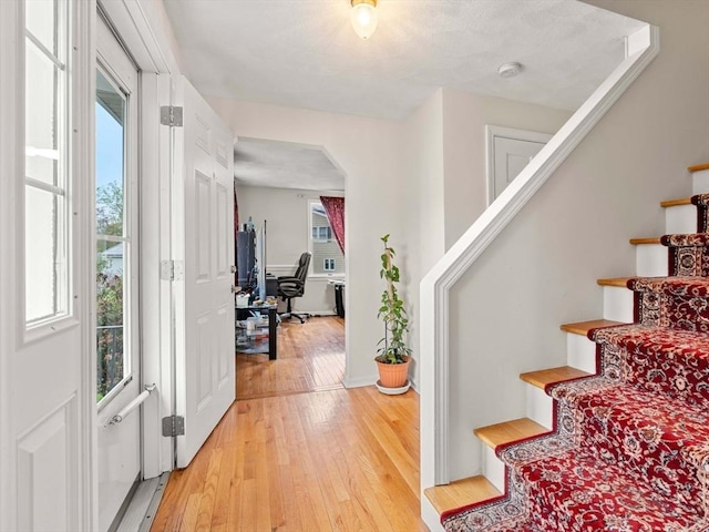 11 Douglas Ave, Burlington, MA 01803 - entryway featuring light wood-style flooring, arched walkways, and plenty of natural light