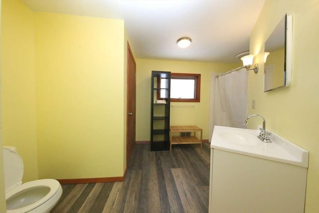 bathroom featuring toilet, vanity, a shower with shower curtain, and hardwood / wood-style flooring