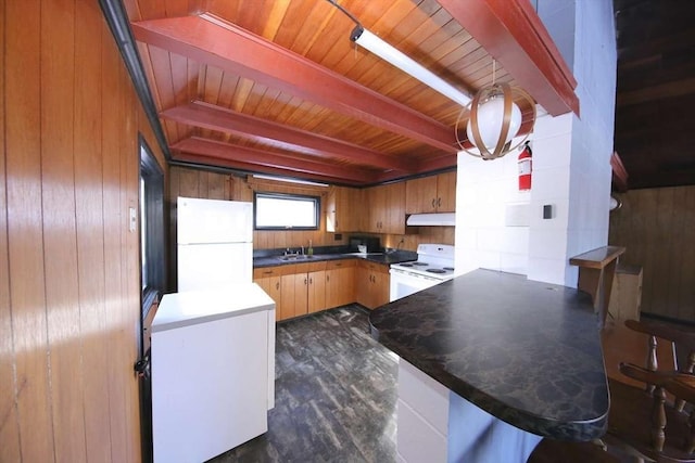 kitchen featuring white appliances, wooden walls, sink, kitchen peninsula, and beam ceiling