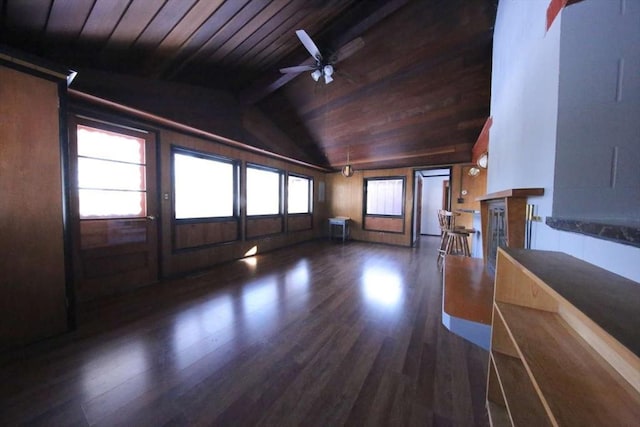 unfurnished living room with ceiling fan, vaulted ceiling, a wealth of natural light, dark wood-type flooring, and wooden ceiling