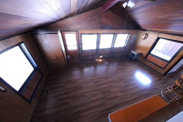 additional living space featuring ceiling fan, wooden ceiling, wood walls, and lofted ceiling