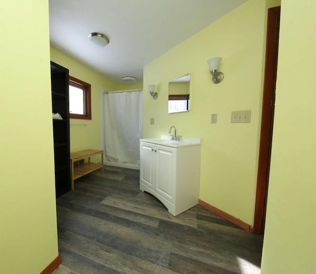 bathroom featuring vanity, hardwood / wood-style floors, and curtained shower