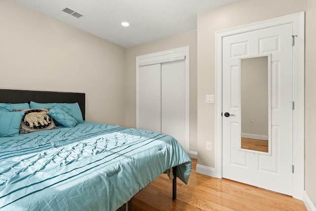 bedroom with hardwood / wood-style flooring and a closet