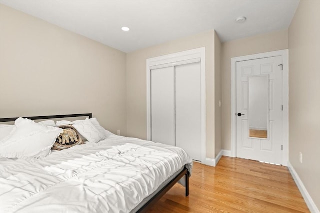 bedroom featuring wood-type flooring and a closet