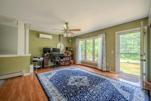 71 Webber Rd, Brookfield, MA 01506 - office featuring a wall mounted air conditioner, ceiling fan, baseboard heating, a textured ceiling, and wood finished floors