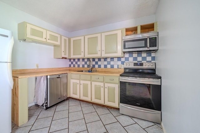 71 Webber Rd, Brookfield, MA 01506 - kitchen featuring stainless steel appliances, cream cabinets, light countertops, and glass insert cabinets