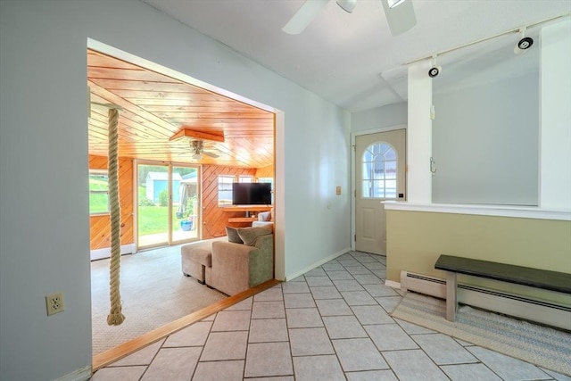71 Webber Rd, Brookfield, MA 01506 - hallway with wood walls, a baseboard radiator, rail lighting, and light tile patterned floors
