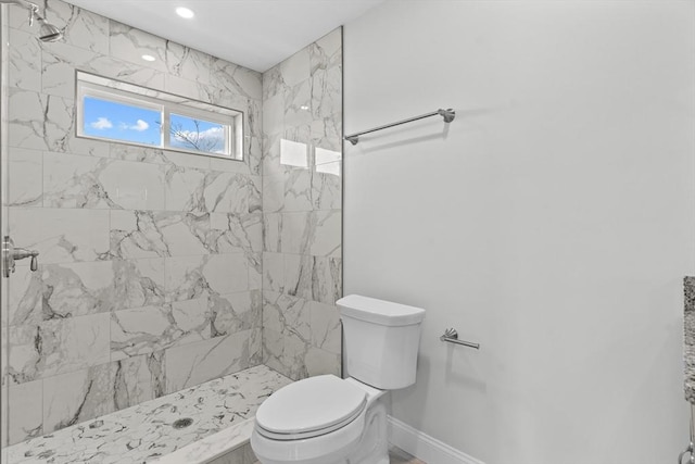 bathroom featuring toilet and tiled shower