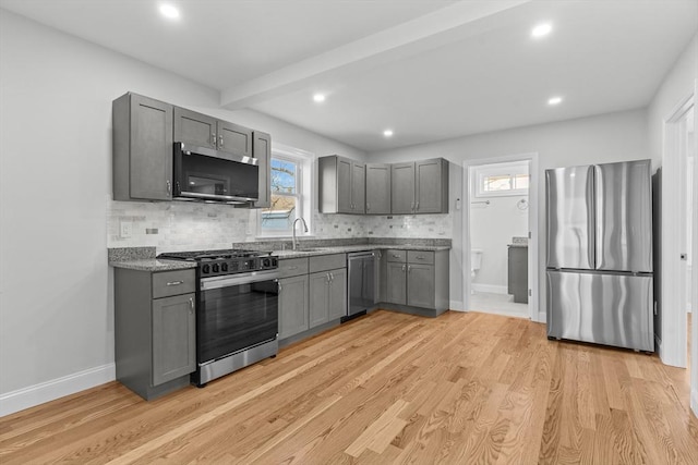 kitchen with light hardwood / wood-style floors, sink, gray cabinetry, and stainless steel appliances