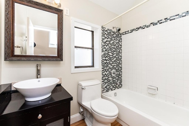 full bathroom featuring baseboards, toilet, vanity, and  shower combination