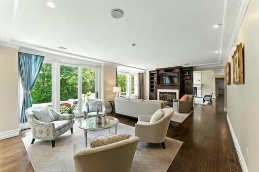 56 Cart Path Rd, Weston, MA 02493 - living area featuring ornamental molding, wood finished floors, and a glass covered fireplace