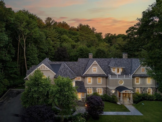 56 Cart Path Rd, Weston, MA 02493 - view of front of house with a balcony, a chimney, a front lawn, and stone siding