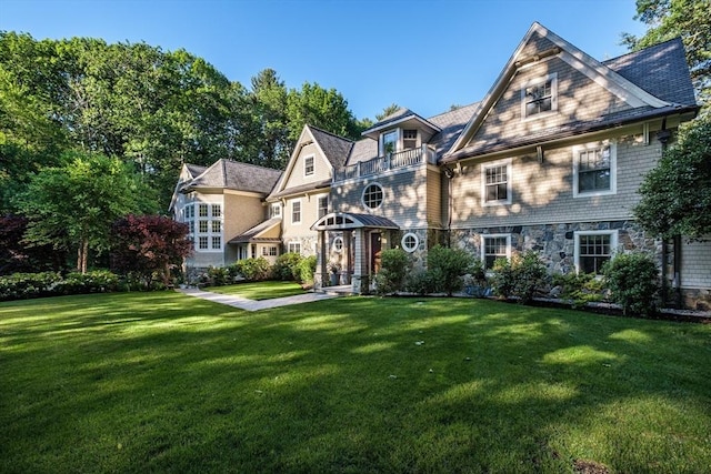 56 Cart Path Rd, Weston, MA 02493 - shingle-style home featuring stone siding, a front lawn, and a balcony