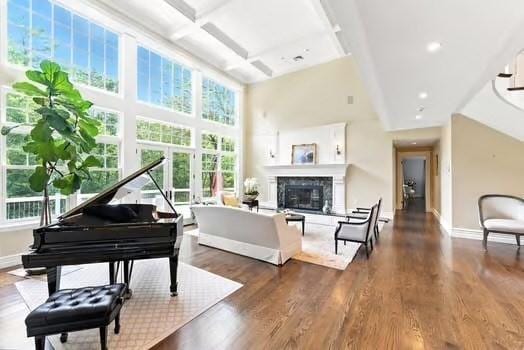 56 Cart Path Rd, Weston, MA 02493 - sitting room with a towering ceiling, coffered ceiling, wood finished floors, plenty of natural light, and a glass covered fireplace