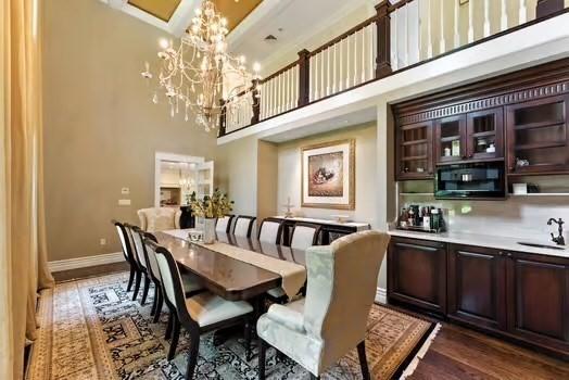 56 Cart Path Rd, Weston, MA 02493 - dining room with a towering ceiling, a chandelier, and dark wood-style floors
