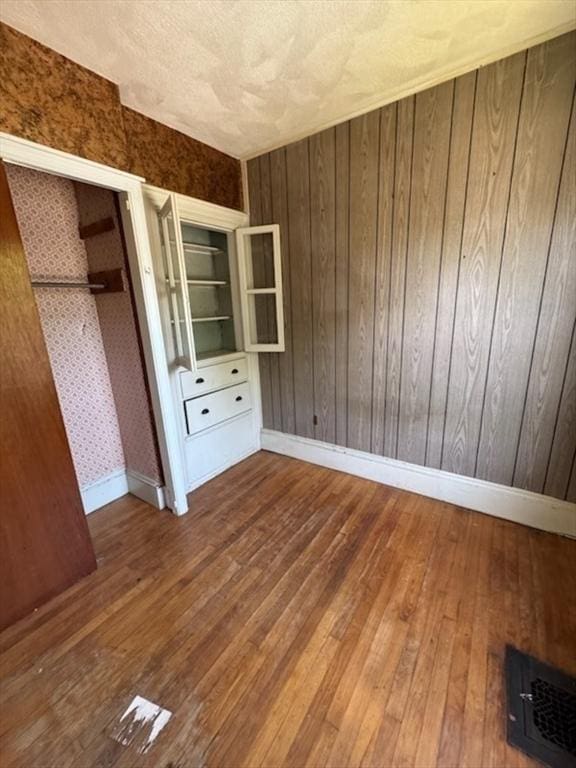 99 Beacon St, Boston, MA 02136 - unfurnished bedroom featuring hardwood / wood-style floors and wooden walls