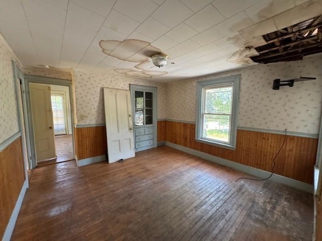99 Beacon St, Boston, MA 02136 - spare room featuring plenty of natural light, a wainscoted wall, hardwood / wood-style floors, wooden walls, and wallpapered walls