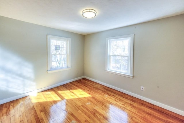 unfurnished room with light wood-type flooring