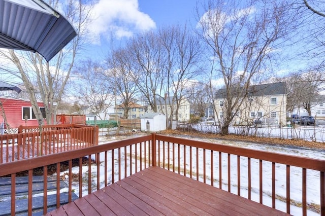 snow covered deck with a storage unit