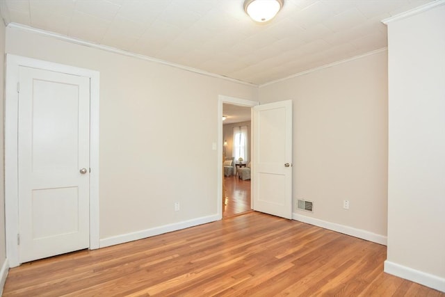 16 W St, Natick, MA 01760 - spare room featuring ornamental molding, light wood-style flooring, and baseboards