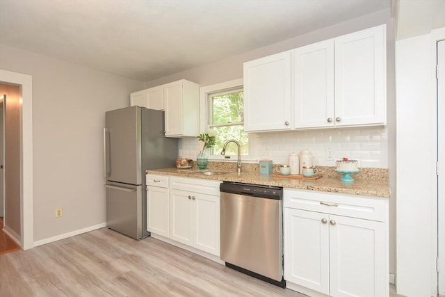 16 W St, Natick, MA 01760 - kitchen with stainless steel appliances, a sink, light wood-type flooring, and white cabinetry