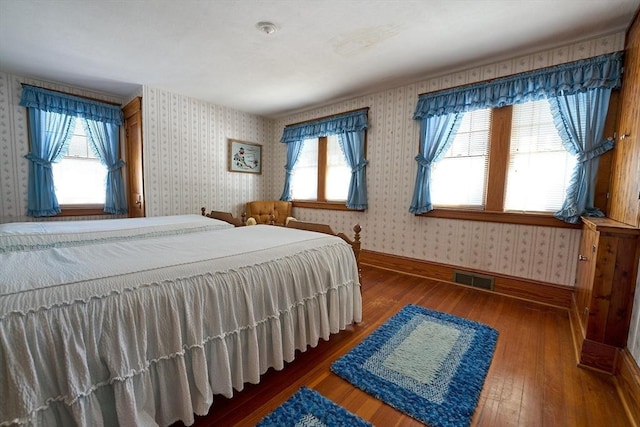 bedroom with dark hardwood / wood-style floors