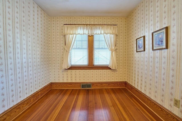 unfurnished room with hardwood / wood-style floors