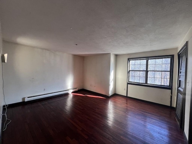 unfurnished room with hardwood / wood-style flooring, baseboards, a baseboard heating unit, and a textured ceiling