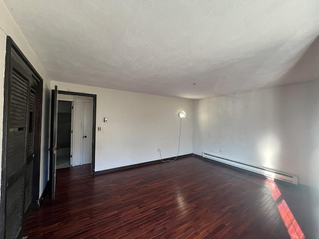 unfurnished room featuring a baseboard radiator, a textured ceiling, baseboards, and dark wood-type flooring