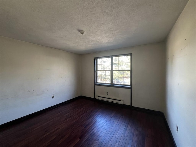 spare room featuring a baseboard radiator, a textured ceiling, baseboards, and dark wood-style flooring