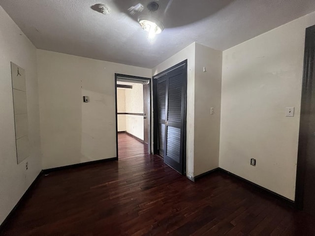 interior space with baseboards and wood finished floors