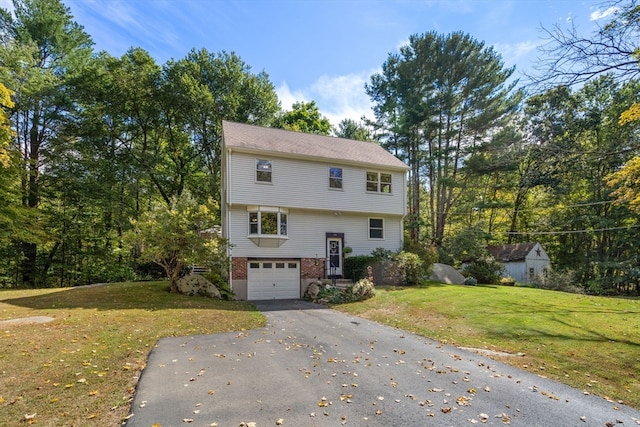 view of front of property with a front yard and a garage